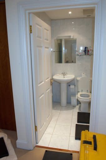 A handout picture released by the Metropolitan Police shows police images of the bathroom of British spy Gareth Williams, whose naked body was found locked inside a holdall in his bath. A coroner has concluded he was probably unlawfully killed