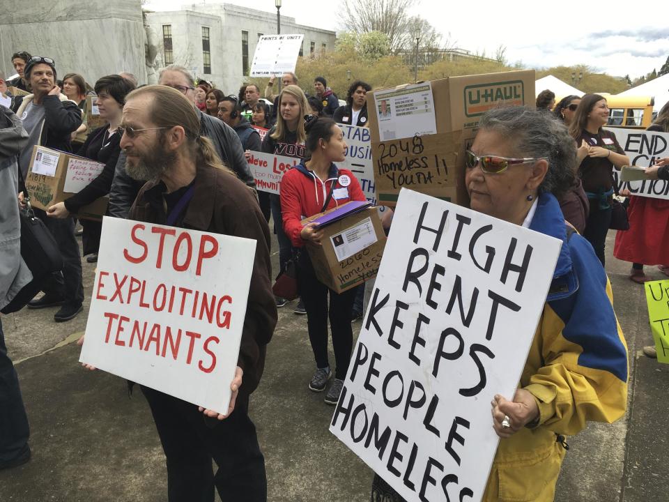 Supporters of a bill to ban most no-cause evictions of home renters in Oregon demonstrate on the Capitol steps in Salem, Ore., in 2017.