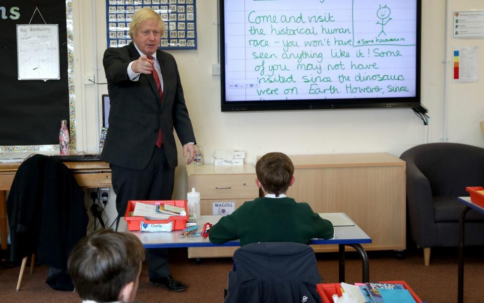 Prime Minister Boris Johnson joins a socially distanced lesson during a visit to Bovingdon Primary School in Bovingdon, Hemel Hempstead - PA
