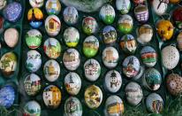 Colourful hand-painted Easter eggs are displayed before German pensioners Christa and Volker Kraft decorate an apple tree with them in the garden of their summerhouse, in the eastern German town of Saalfeld, March 19, 2014. Each year since 1965 Volker and his wife Christa spend up to two weeks decorating the tree with their collection of 10,000 colourful hand-painted Easter eggs in time for Easter celebrations. REUTERS/Fabrizio Bensch