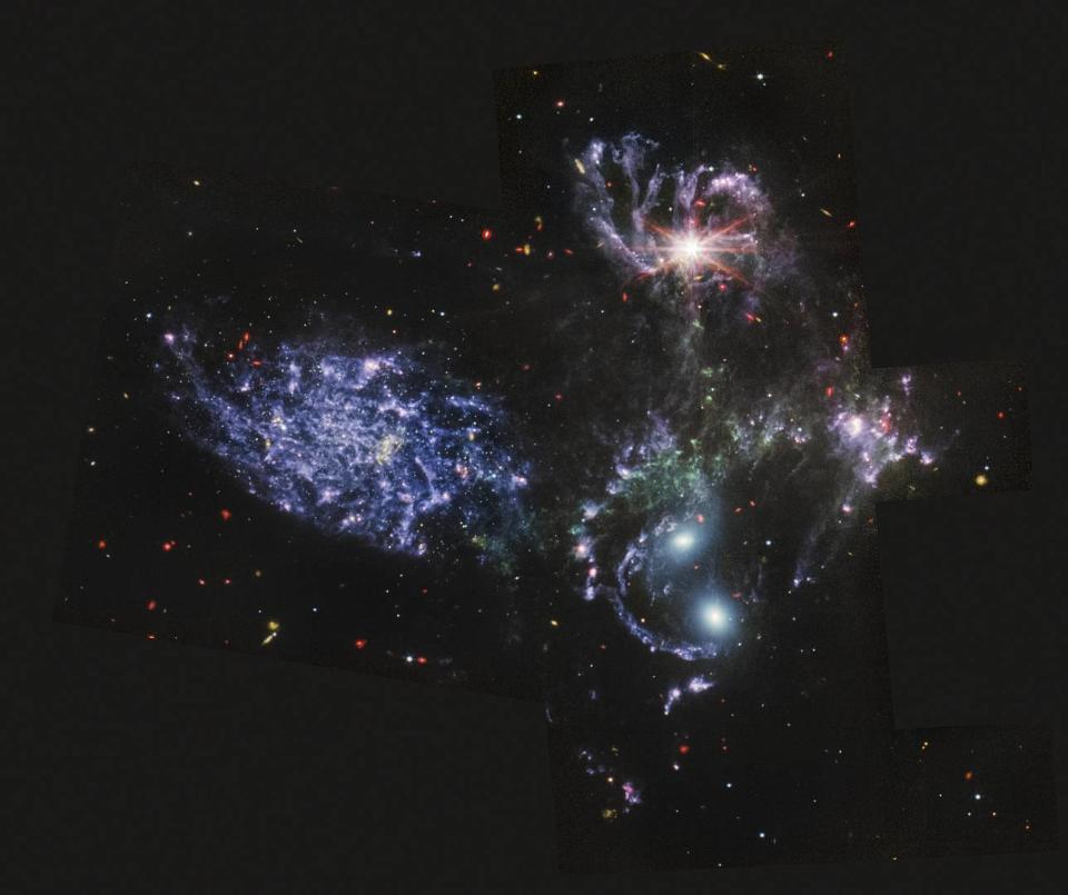 This image provided by NASA on Tuesday, July 12, 2022, shows Stephan's Quintet, a visual grouping of five galaxies captured by the Webb Telescope's Mid-Infrared Instrument (MI