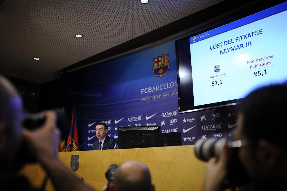 FC Barcelona's president Josep Maria Bartomeu attends a press conference at the Camp Nou stadium in Barcelona, Spain, Friday, Jan 24, 2014. Barcelona says its board of directors is calling an ''extraordinary'' meeting, fueling Spanish media reports that club president Sandro Rosell is under pressure to consider stepping down due to the lawsuit regarding Neymar's transfer. Barcelona said in a statement that the meeting will take place on Thursday afternoon, a day after a judge agreed to hear a lawsuit brought by a Barcelona club member over the cost of Neymar's signing. The screen reads in Catalan: "Cost of signing Neymar JR". (AP Photo/Manu Fernandez)