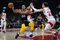 Memphis Grizzlies guard Desmond Bane (22) passes the ball as Toronto Raptors guard Malachi Flynn (22) defends during the first half of an NBA basketball game Tuesday, Nov. 30, 2021, in Toronto. (Nathan Denette/The Canadian Press via AP)