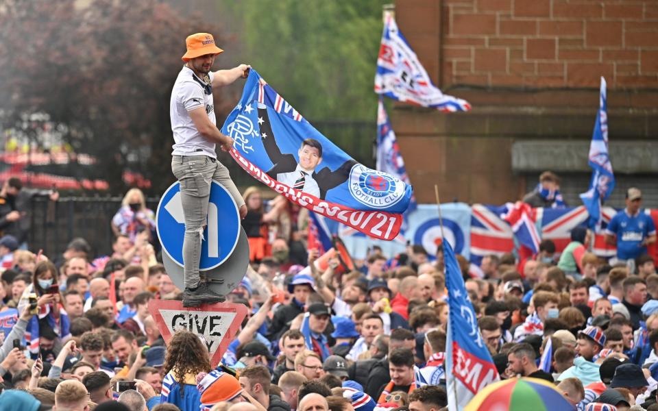 Fans celebrate winning the Scottish Premiership title outside the Ibrox Stadium in Glasgow, Scotland - Jeff J Mitchell / Getty