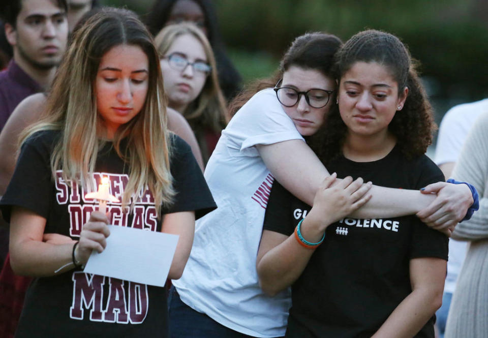 Students grieve during a candlelight vigil at Memory Mall on the UCF campus in Orlando, Fla., in commemoration of the one-year anniversary of the mass shooting at Marjory Stoneman Douglas High School, on Thursday, Feb. 14, 2019. (Stephen M. Dowell/Orlando Sentinel/TNS via Getty Images)