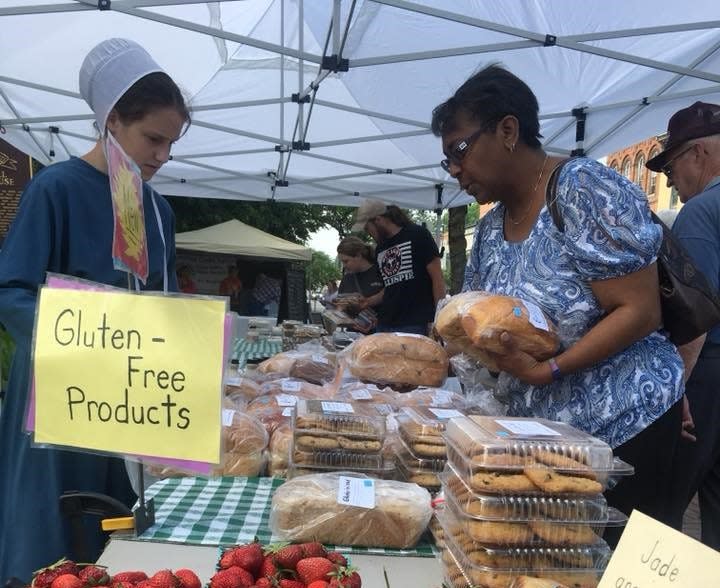 A customer surveys a vendor's baked goods at last year's Main Street Delaware Farmers Market. This year, the market opens May 25.