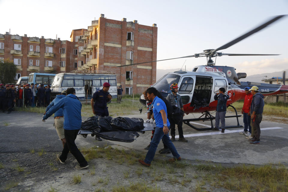 Rescuers retrieved the bodies of five South Korean climbers and their four Nepalese guides from Gurja Himal mountain, where they were killed when their base camp was swept by a strong storm. (AP Photo/Niranjan Shrestha)