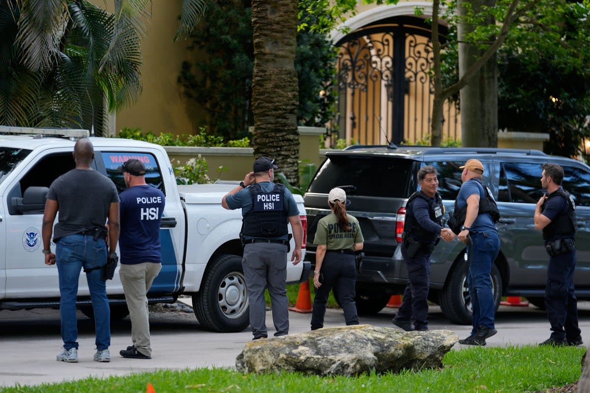 Law enforcement at the entrance to Sean Combs’ Miami Beach property in March (AP)