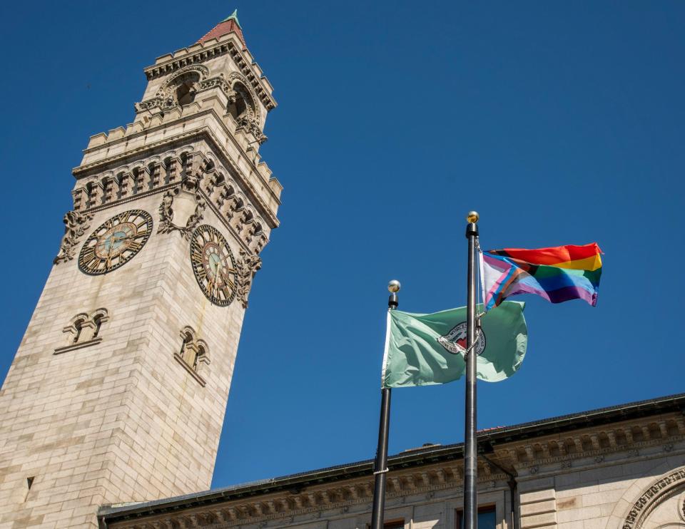 A Pride flag flies next to the city flag in front of City Hall Thursday, August 31, 2023.
