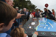 <p>A group of visitors look at the D-Day landing map located at the American Cemetery in Colleville-sur-Mer. (Photo: Artur Widak/NurPhoto via Getty Images) </p>