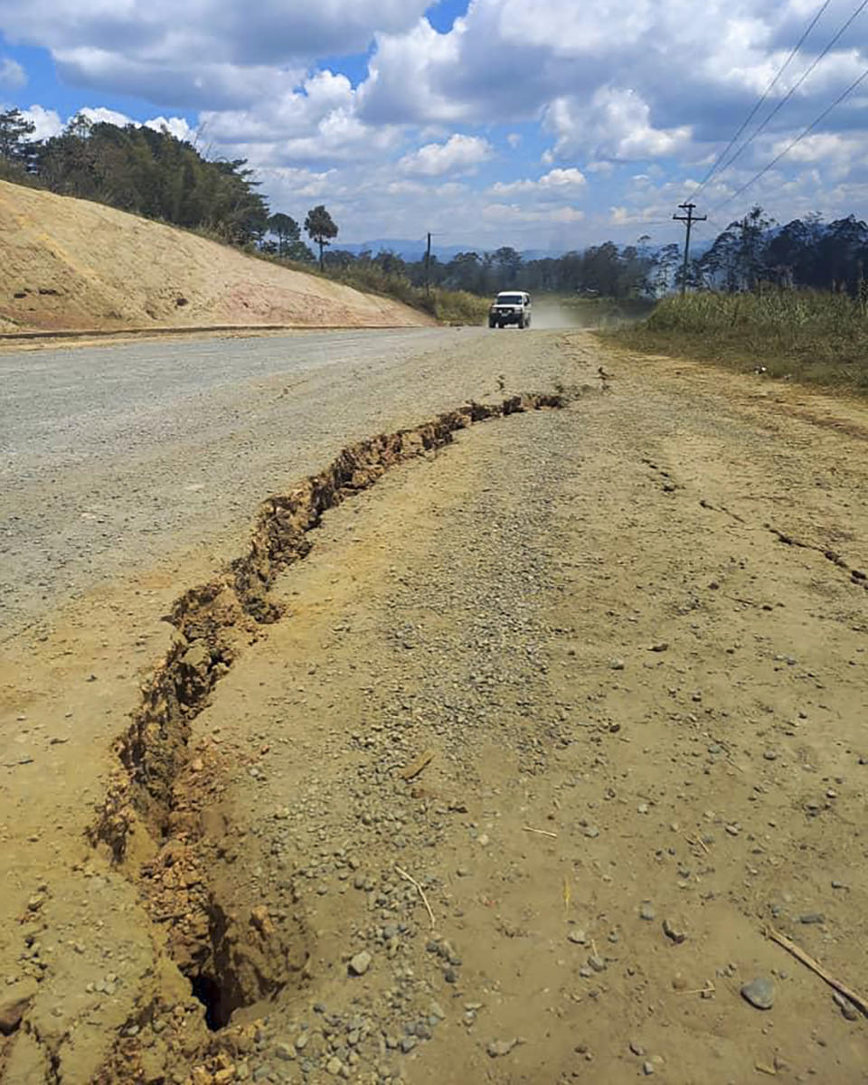 A large crack is seen in a highway near the town of Kainantu, following a 7.6-magnitude earthquake in northeastern Papua New Guinea, Sunday, Sept. 11, 2022. The quake hit at 9:46 a.m. local time, with the epicenter 67 kilometers (42 miles) east of Kainantu, a sparsely populated area. (Renagi Ravu via AP)