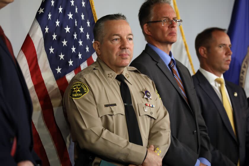 Santa Ana, California-July 18, 2022-Los Angeles County Sheriff Alex Villanueva listens as Orange County District Attorney Todd Spitzer announce the charges against two suspects in the 7-Eleven crime spree, at the Orange County District Attorney's Office in Santa Ana, California on July 18, 2022. (Carolyn Cole / Los Angeles Times)