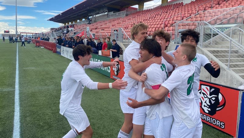 Rowland Hall's Kelton Ferriter celebrates with teammates after scoring the game winning goal in the the 2A semifinal at Zions Banks Stadium on Thursday, May 9, 2024.