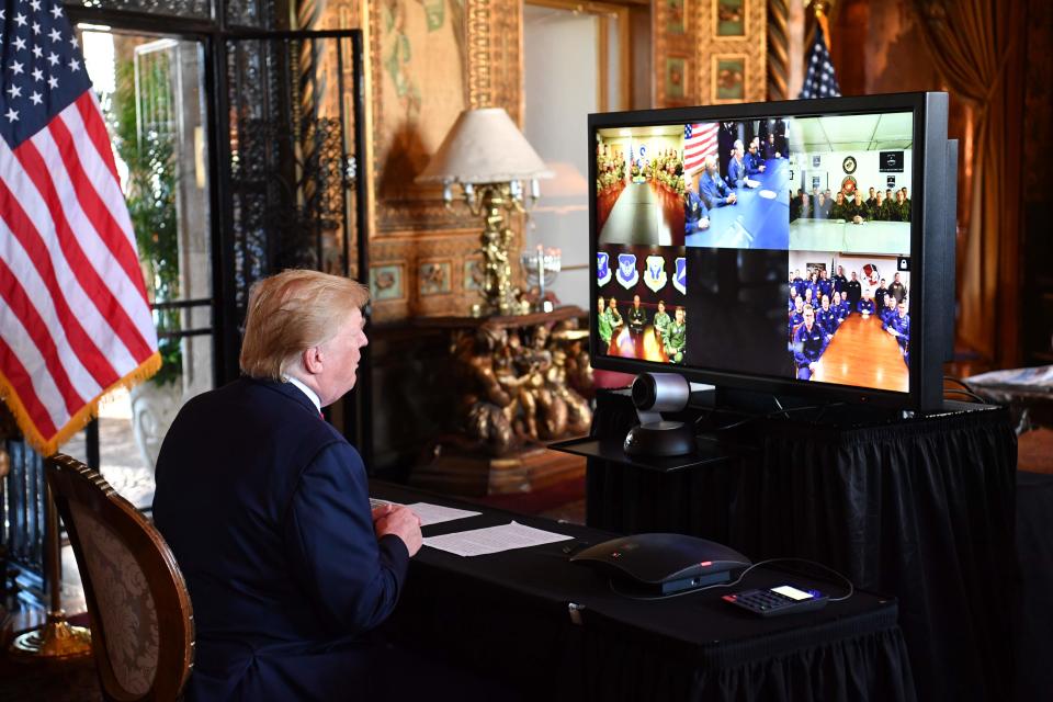 President Donald Trump makes a video call to the troops stationed worldwide at the Mar-a-Lago estate in Palm Beach Florida, on Tuesday, which is Christmas Eve.