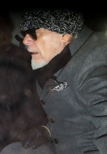 Former British rock star Gary Glitter, whose real name is Paul Gadd, returns home in central London on October 28, 2012, after he was arrested earlier in the day by British police