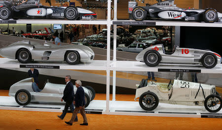 Two men walk past vintage Mercedes-Benz cars at the Techno-Classic classic car fair in Essen March 26, 2014. REUTERS/Ina Fassbender/File Photo