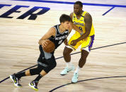 Sacramento Kings' Bogdan Bogdanovic (8) drives against Los Angeles Lakers' Dion Waiters (18) during the second quarter of an NBA basketball game Thursday, Aug. 13, 2020, in Lake Buena Vista, Fla. (Kevin C. Cox/Pool Photo via AP)