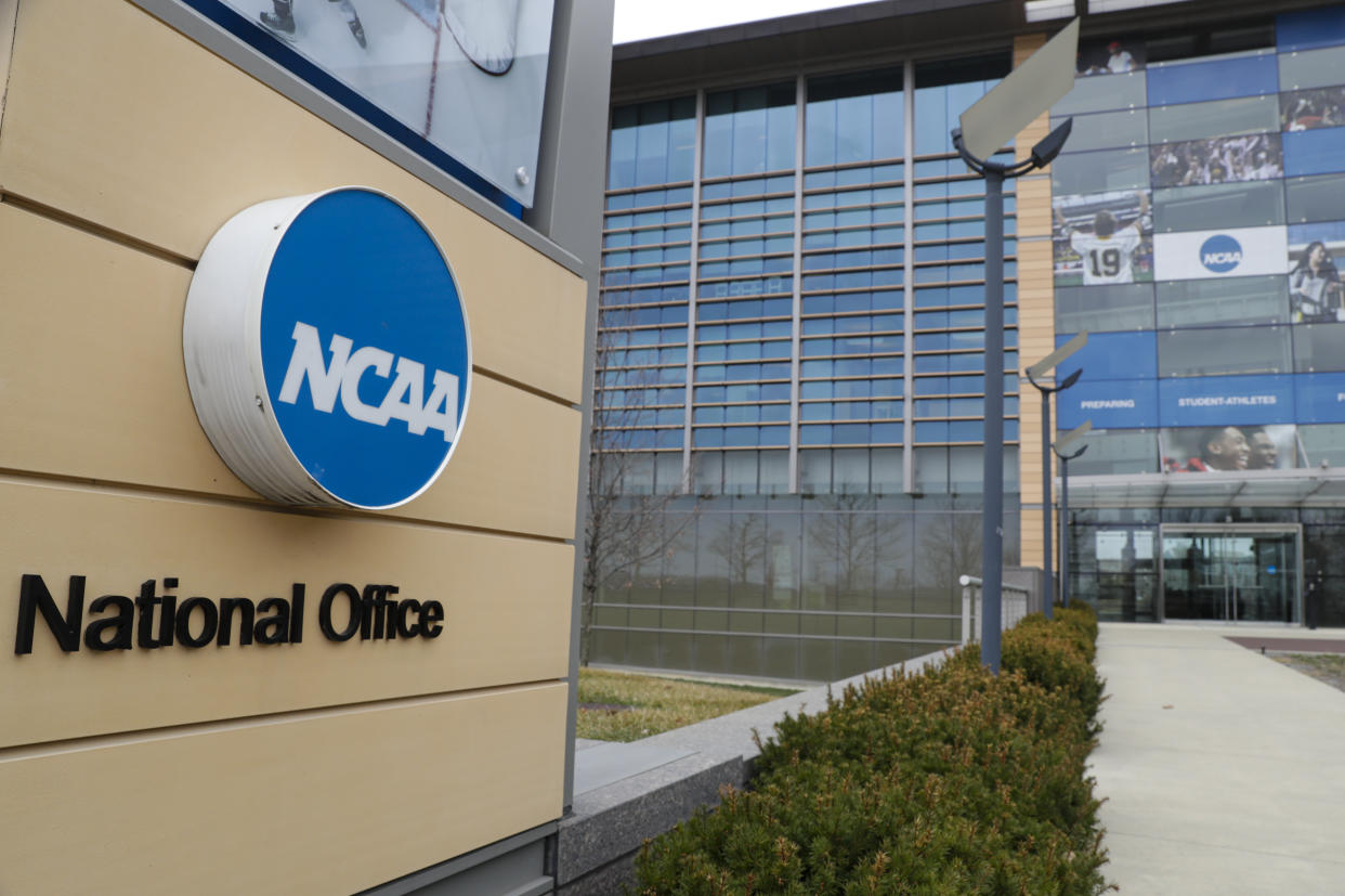 FILE - This is a March 12, 2020, file photo showing NCAA headquarters in Indianapolis. A lawsuit filed in West Virginia’s northern district challenges the NCAA’s authority to impose a one-year delay in the eligibility of certain athletes who transfer between schools. The suit said the rule “unjustifiably restrains the ability of these college athletes to engage in the market for their labor as NCAA Division I college athletes.”(AP Photo/Michael Conroy, File)