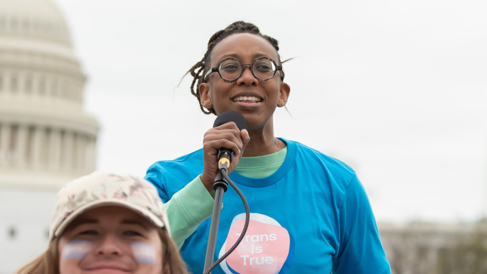 Kelley Robinson, Human Rights Campaign president, speaks at a Washington rally that drew more than 1,000 people on March 31 and was organized by the Queer Youth Assembly in honor of Transgender Day of Visibility. Robinson told theGrio that “our trans family and our trans youth” are especially at risk. (Photo: Joy Asico/AP Images for Human Rights Campaign)