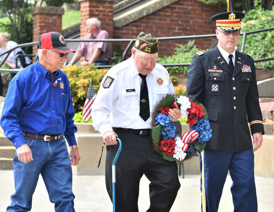 Wreaths are laid upon gravestones during a Memorial Day ceremony in Windthorst on Monday, May 29, 2023.