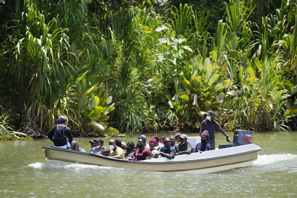 Migrants arrive on a boat to Acandi, Colombia, Tuesday, Sept. 14, 2021. The migrants, following a well-beaten, multi-nation journey towards the U.S., will continue their journey through the jungle known as the Darien Gap. (AP Photo/Fernando Vergara)