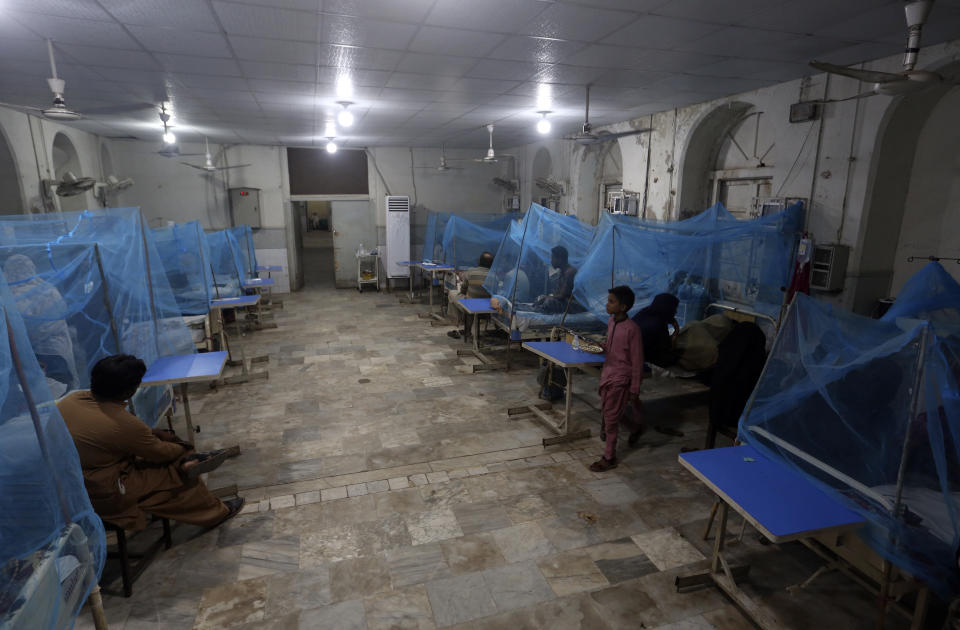 Pakistani patients suffering from dengue fever, a mosquito-borne disease, are treated in an isolation ward, at a hospital in Karachi, Pakistan, Saturday, Sept. 24, 2022. Pakistan has deployed thousands of additional doctors and paramedics in the country's worst flood-hit province to contain the spread of diseases that have killed hundreds of people among the flood victims, officials said Friday. (AP Photo/Fareed Khan)