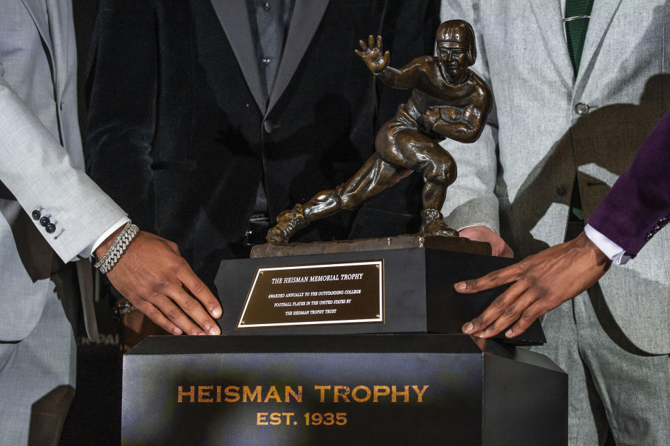 Heisman Trophy finalists, from left, LSU quarterback Jayden Daniels, Ohio State wide receiver Marvin Harrison Jr., Oregon quarterback Bo Nix and Washington quarterback Michael Penix Jr. pose with the trophy after attending a news conference before the award ceremony, Saturday, Dec. 9, 2023, in New York. (AP Photo/Eduardo Munoz Alvarez)