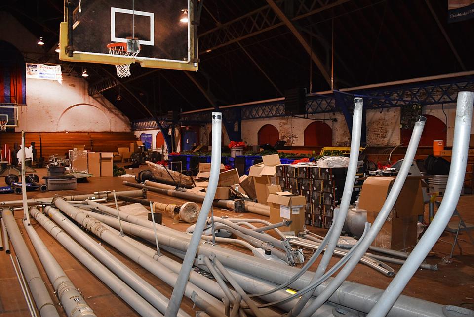 The basketball court at the Bank Street Armory, on Bank Street in Fall River, is used to store old streetlight poles.