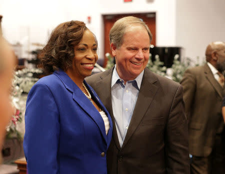 Democratic Alabama U.S. Senate candidate Doug Jones pose with a member of the Progressive Union Missionary Baptist Church after he spoke in Huntsville, Alabama, U.S. December 10, 2017. REUTERS/Marvin Gentry