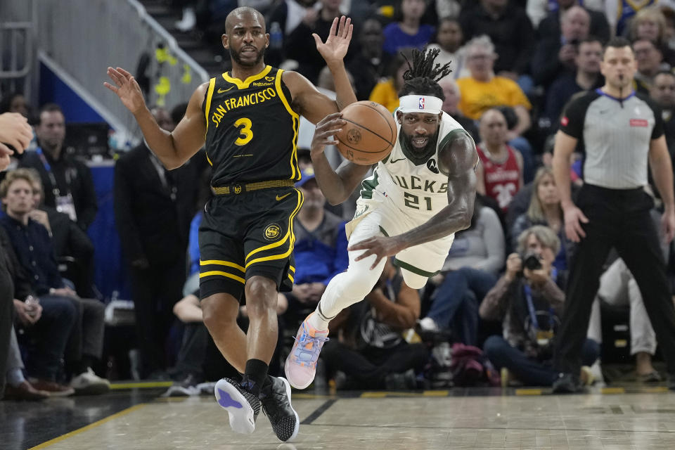 Milwaukee Bucks guard Patrick Beverley (21) dives for the ball next to Golden State Warriors guard Chris Paul (3) during the first half of an NBA basketball game in San Francisco, Wednesday, March 6, 2024. (AP Photo/Jeff Chiu)