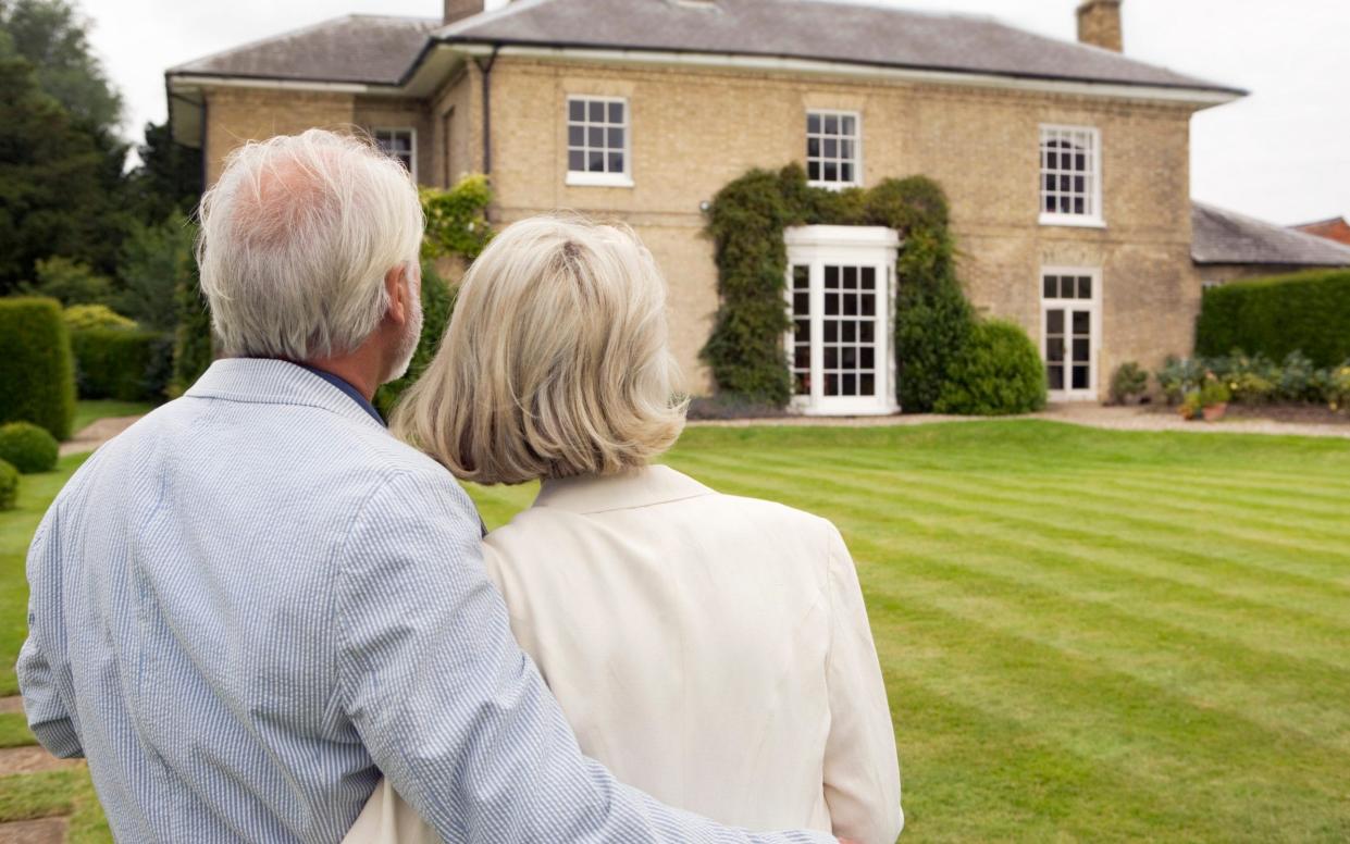 Senior Couple Admiring House