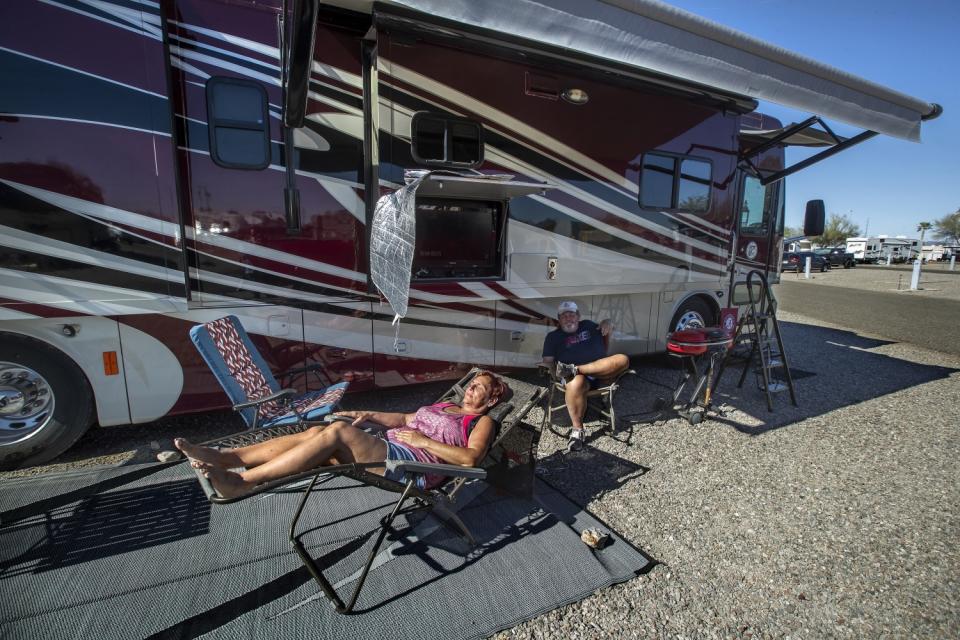 Janna and John Wilson sunbathe next to their 40 foot long motorhome located at Quail Run RV Park in Quartzsite, Arizona.