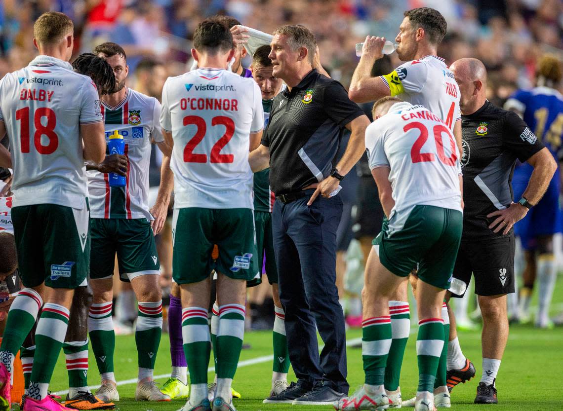 Wrexham head coach Phil Parkinson talks with his players during a mandatory cooling off period in the first half against Chelsea during their FC Series game on Wednesday, July 19, 2023 at Kenan Stadium in Chapel Hill, N.C.