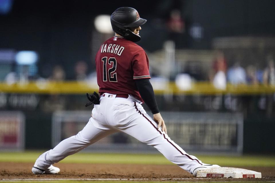 Arizona Diamondbacks' Daulton Varsho pauses at first base after getting caught in a rundown for an out during the first inning of a baseball game against the Colorado Rockies, Sunday, Aug. 7, 2022, in Phoenix. (AP Photo/Ross D. Franklin)