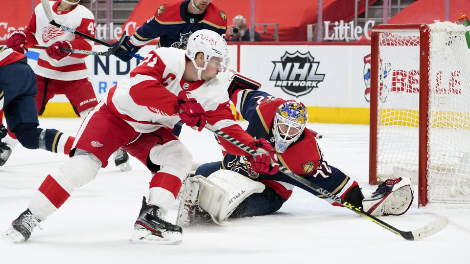 Florida Panthers goaltender Sergei Bobrovsky (72) defends Detroit Red Wings center Dylan Larkin (71) in the second period of an NHL hockey game Saturday, Feb. 20, 2021, in Detroit. (AP Photo/Paul Sancya)