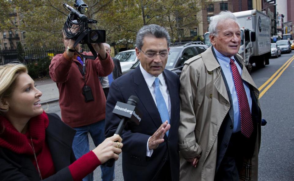Former Goldman Sachs and Procter & Gamble Co. board member Rajat Gupta, center, declines to answer a question from a reporter as he arrives outside federal court in New York Wednesday, Oct. 24, 2012. Gupta is to be sentenced after being found guilty insider trading by passing secrets between March 2007 and January 2009 to a billionaire hedge fund founder who used the information to make millions of dollars. At right is Gupta's attorney Gary Naftalis. (AP Photo/Craig Ruttle)