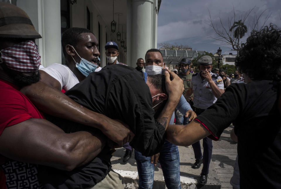 Plainclothes police detain an anti-government protester during a protest in Havana, Cuba, Sunday, July 11, 2021. Hundreds of demonstrators went out to the streets in several cities in Cuba to protest against ongoing food shortages and high prices of foodstuffs, amid the new coronavirus crisis. (AP Photo/Ramon Espinosa)