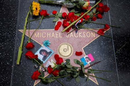 Jackson fans sing, sob, leave sunflowers and roses on 10th anniversary of  death