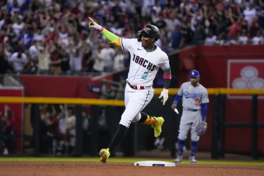 Arizona Diamondbacks’ Geraldo Perdomo celebrates as he rounds the bases after hitting a home run during the third inning in Game 3 of a baseball NL Division Series against the Los Angeles Dodgers, Wednesday, Oct. 11, 2023, in Phoenix. (AP Photo/Rick Scuteri)