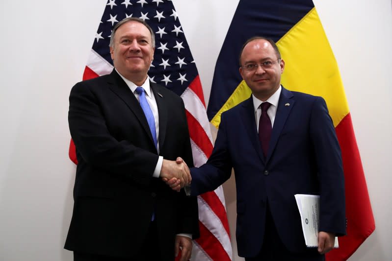 U.S. Secretary of State Pompeo poses with Romania's Foreign Minister Aurescu during a NATO foreign ministers meeting in Brussels