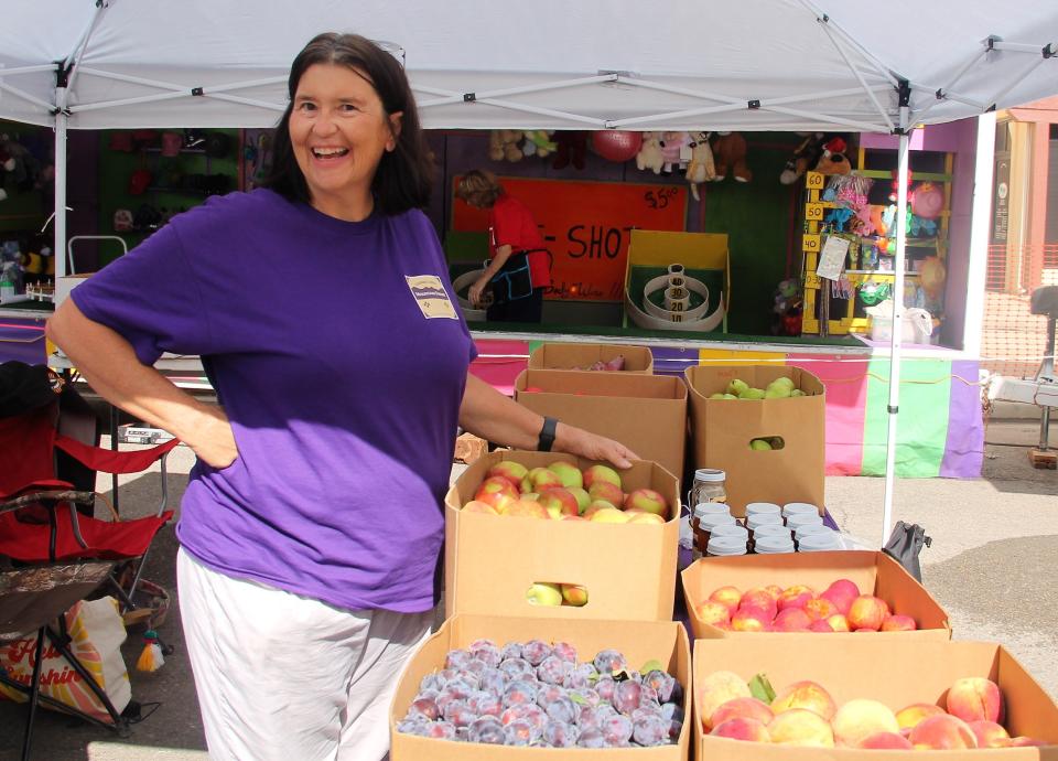 Angie Cadwallader of Cadwallader Mountain Farms, who also serves as on the Alamogordo Public Schools Board of Education, shows off plums, peaches apples and jams at the Cadwallader Farms booth at the Otero County Heritage Festival.

The Otero County Heritage Festival was held Saturday, August 20, 2022 on the 1100 block of New York Avenue in Alamogordo. The event featured a wild west show, chile roasting, art and photography exhibits in Patrons Hall and local vendors  including Cadwallader Mountain Farms, Nichols Ranch and Orchards and The Local Bodega.