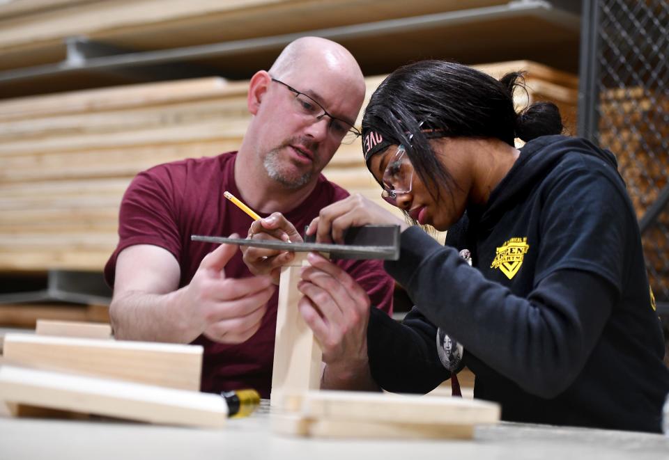 Freshman Denazha Buchanan of Worcester is taught to make a joint box by carpentry teacher Mike Cormier at Worcester Technical High School.