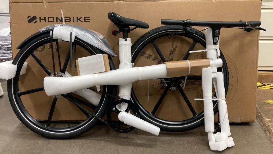 Honbike Uni4 e-bike in packaging next to delivery box