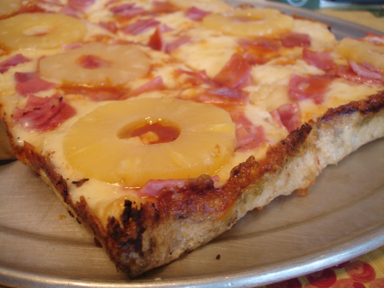 A slice of Hawaiian pan pizza