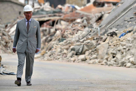 Britain's Prince Charles walks during his visit to the town of Amatrice, which was levelled after an earthquake last year, in central Italy April 2, 2017. REUTERS/Emiliano Grillotti