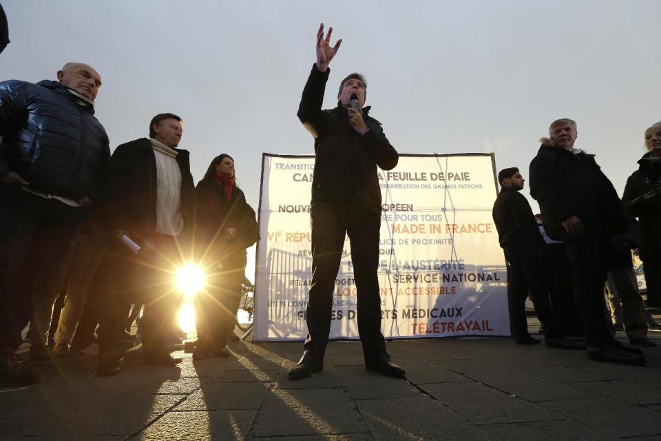 Former Economy minister and now candidate in the French left's presidential primaries Arnaud Montebourg, center, talks during a stand-up in the Old-Port of Marseille, southern France, Friday, Jan. 20, 2017. Seven competitors are bidding to be the Socialist Party's candidate in next spring's French presidential election. Banner reads "Candidate of the pay slip-New European treaty". (AP Photo/Claude Paris)