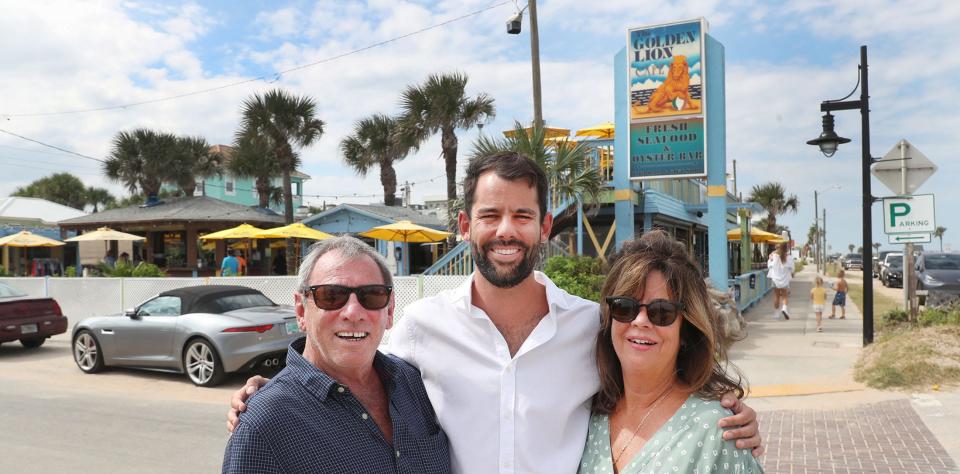 Golden Lion Cafe owners Tony Marlow, left, stands with his son Christopher and wife, Carolyn, outside the beloved longtime restaurant and beach bar in Flagler Beach. The secret to the Golden Lion's success? "You treat people the way you’d like to be treated,” Tony said.