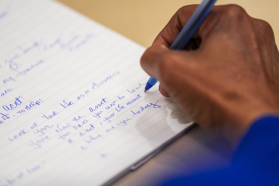 Karen Tucker takes notes during a class on finical investments held through the The Kroc Center and Salvation Army in South Phoenix on Wednesday, March 9, 2022, in Phoenix. The class is a part of a 10-week financial literacy course.