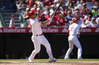 Los Angeles Angels' Mike Trout (27) hits a home run during the fourth inning of a baseball game against the Texas Rangers in Anaheim, Calif., Sunday, Oct. 2, 2022. (AP Photo/Ashley Landis)