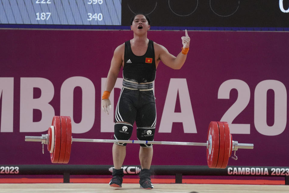 Vietnam's Quoc Toan Nguyen celebrates during in the men's 89-kilogram weightlifting final match at the 32nd Southeast Asian Games in Phnom Penh, Cambodia, Tuesday, May 16, 2023. (AP Photo/Tatan Syuflana)